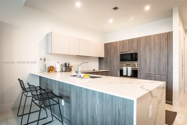 a kitchen with a stove a sink and a refrigerator