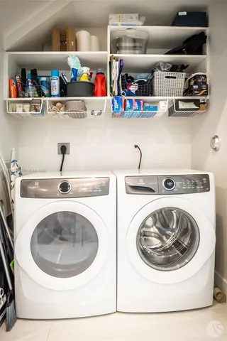 a utility room with sink dryer and washer
