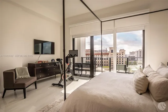 a bedroom with a bed and large window