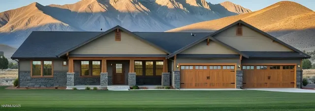 a front view of a house with a garden and plants