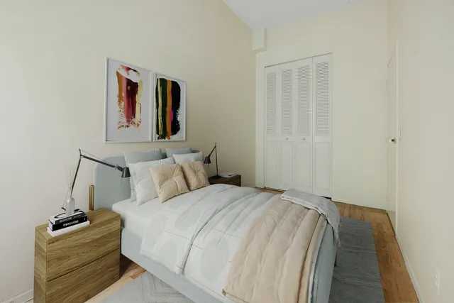 a bedroom with a bed and a window