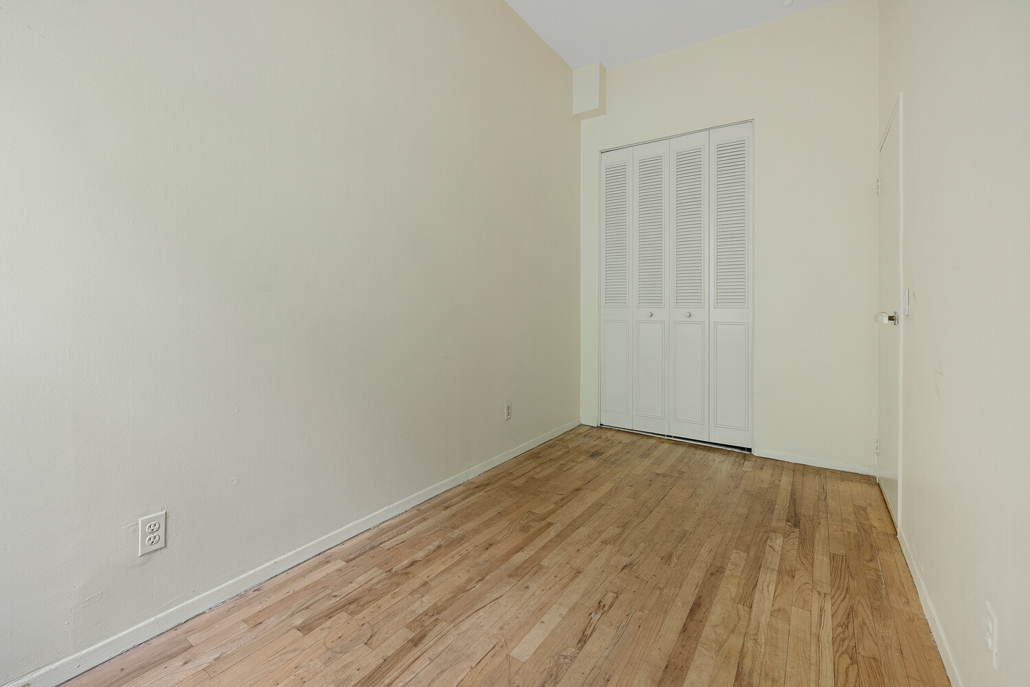 359 West 30th Street, Unit 2B Manhattan, NY 10001 - Photo 15 of 16 a view of an empty room with wooden floor