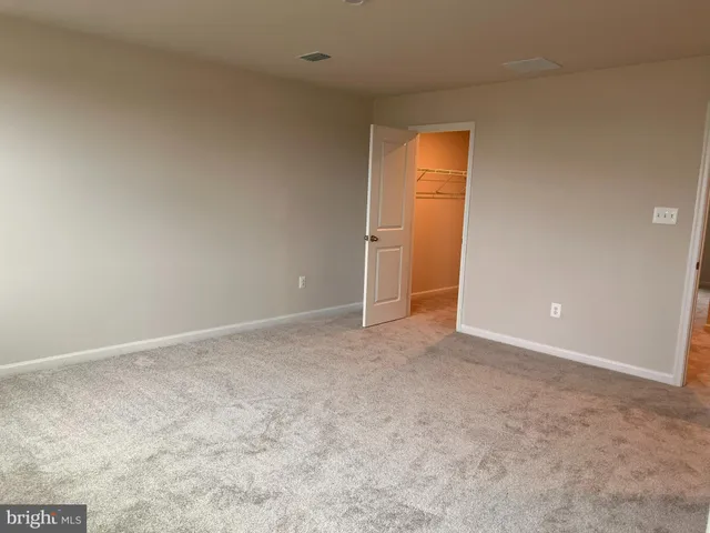 a view of an empty room and a window