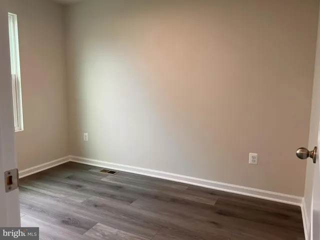 wooden floor and cabinet in an empty room