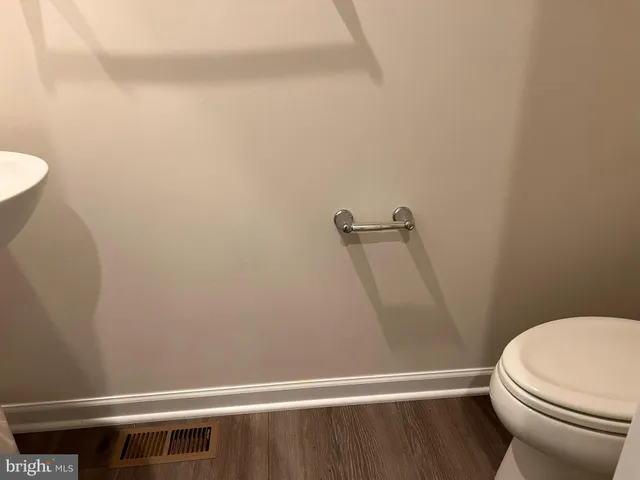 a white toilet sitting next to a shower