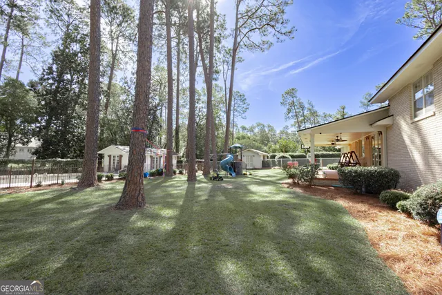 a swimming pool with outdoor seating and yard