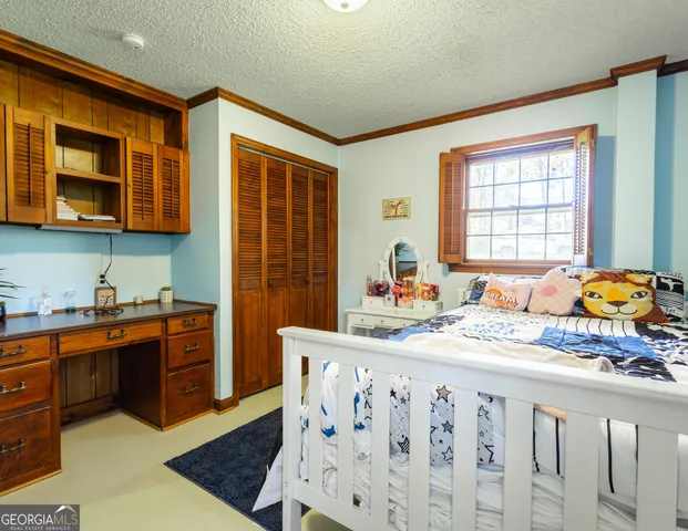 a bedroom with furniture and a window