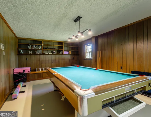 a room with furniture and pool table