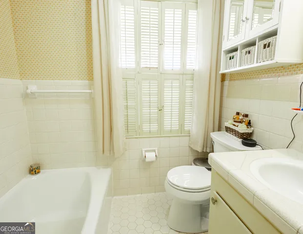 a bathroom with a sink a toilet and a bathtub