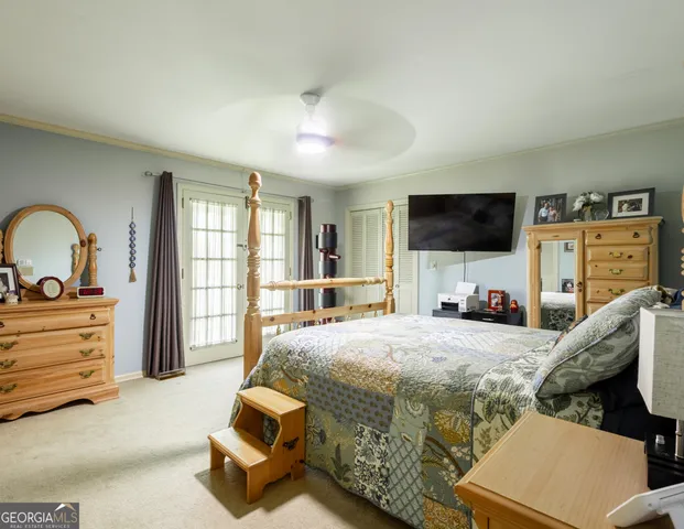 a bedroom with a bed and flat screen tv