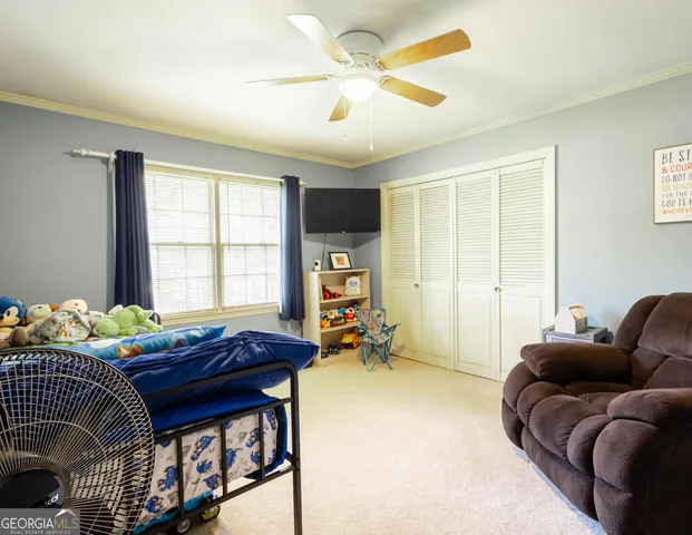 a bedroom with furniture and a window