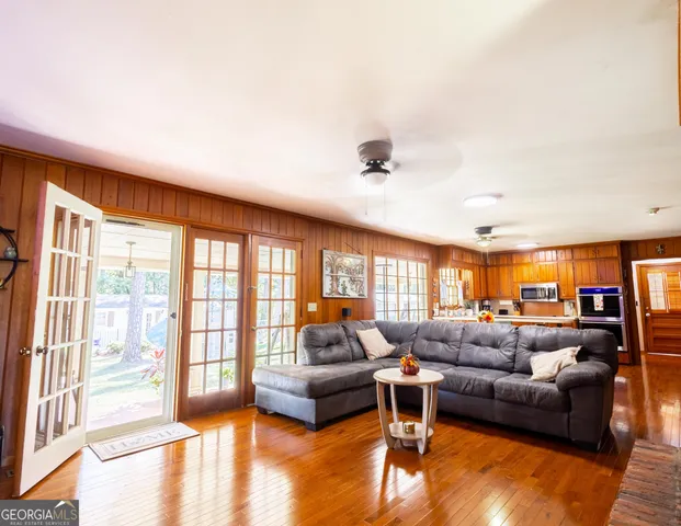 a living room with furniture a fireplace and wooden floor