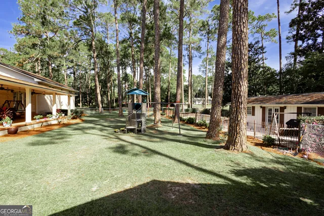 a view of a house with swimming pool and sitting area