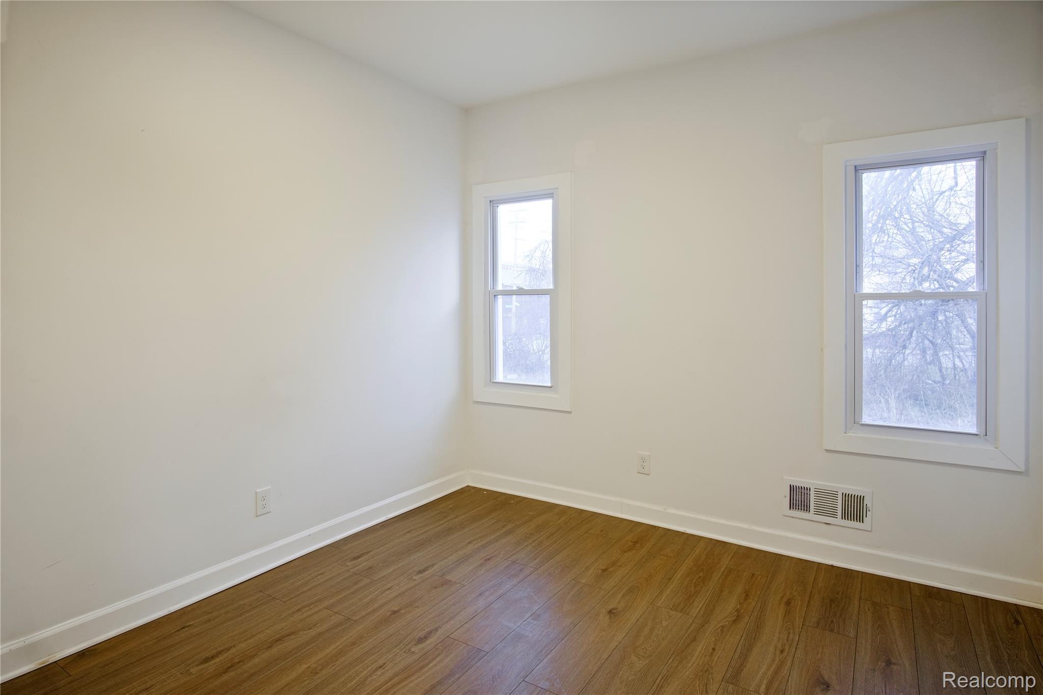 6123 Commonwealth Street Detroit, MI 48208 - Photo 10 of 14 Spare room with baseboards and dark wood-style flooring