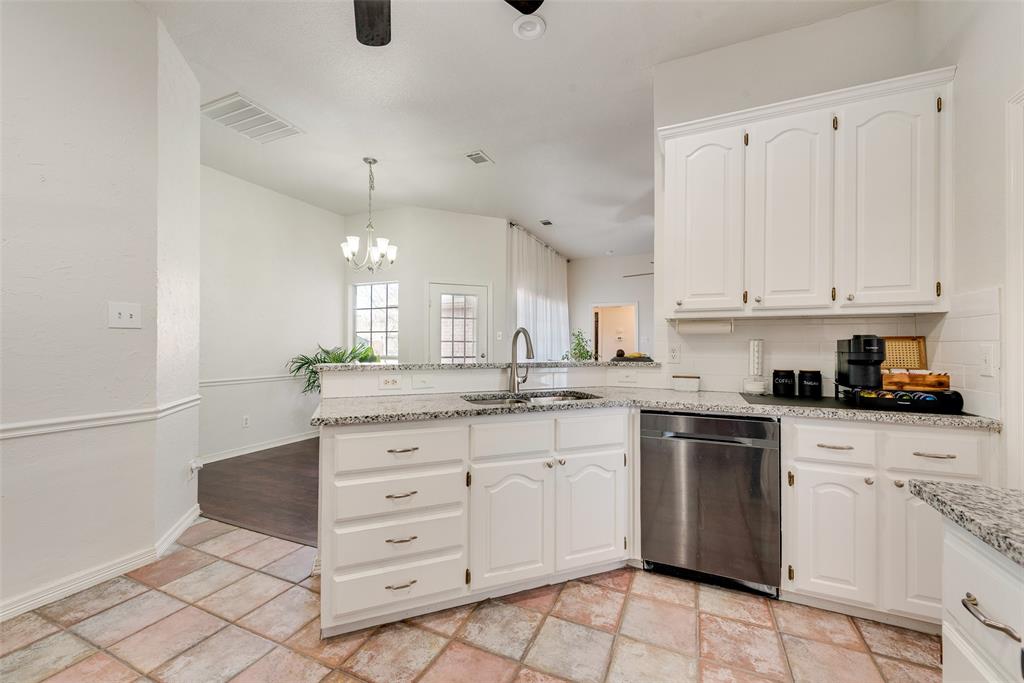 106 Villanova Circle Forney, TX 75126 - Photo 12 of 26 a kitchen with granite countertop white cabinets white appliances and sink