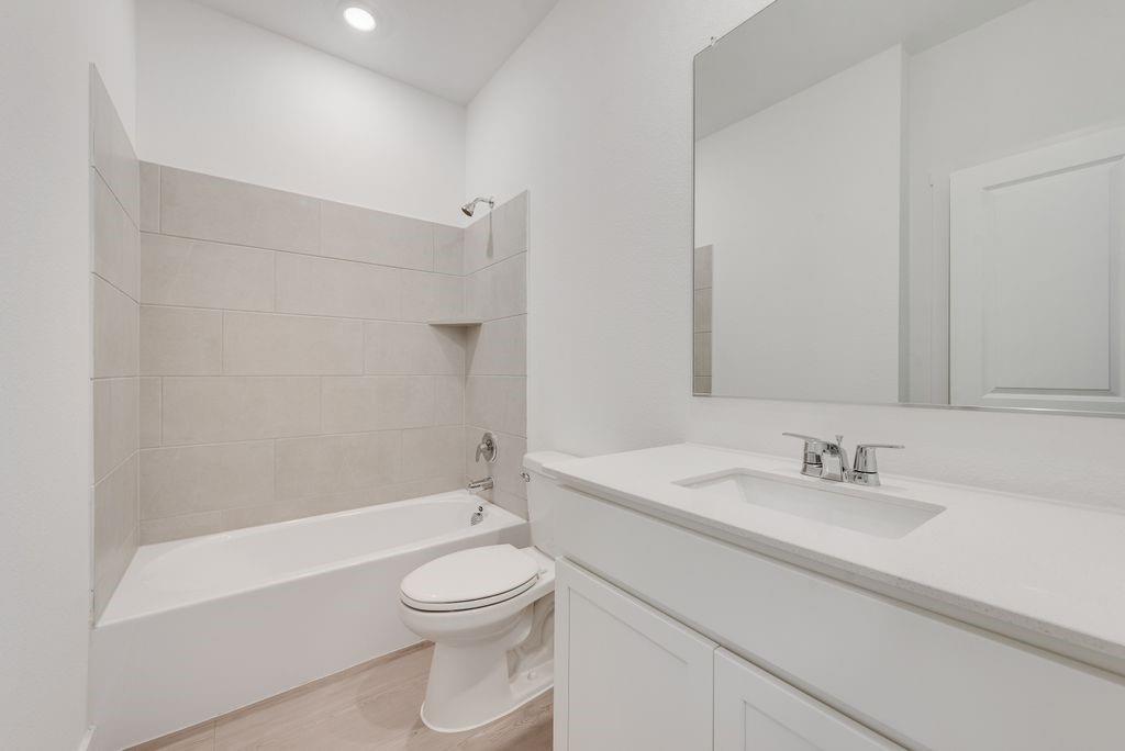 3009 Dutch Road Providence Village, TX 76227 - Photo 13 of 19 a bathroom with a sink a toilet and a bathtub