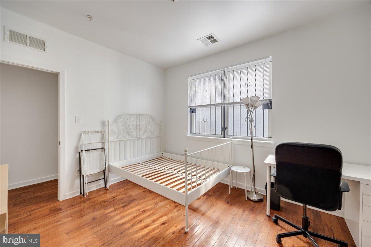 1322 North 15th Street, Unit A Philadelphia, PA 19121 - Photo 11 of 27 a bedroom with a bed and a window
