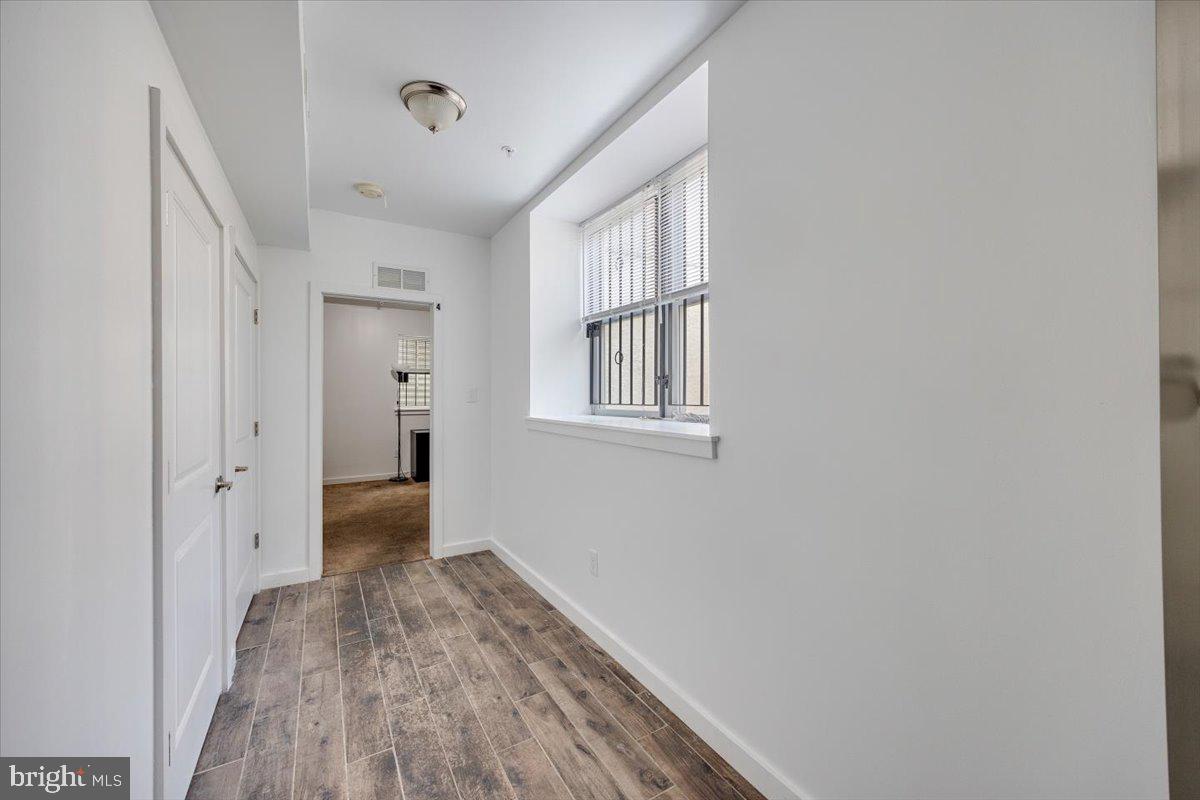 1322 North 15th Street, Unit A Philadelphia, PA 19121 - Photo 15 of 27 a view of a hallway with wooden floor and a bathroom