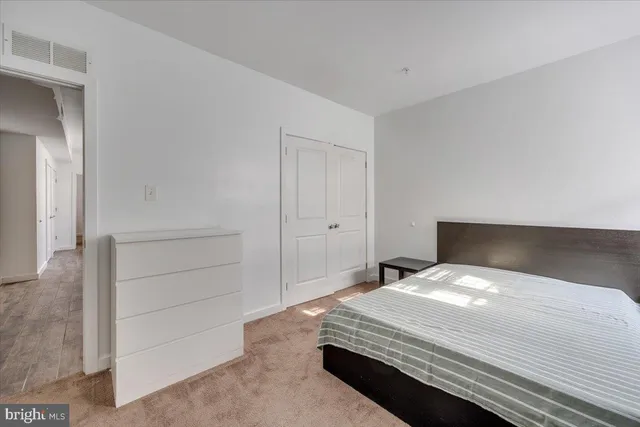 a bedroom with a bed and cabinet