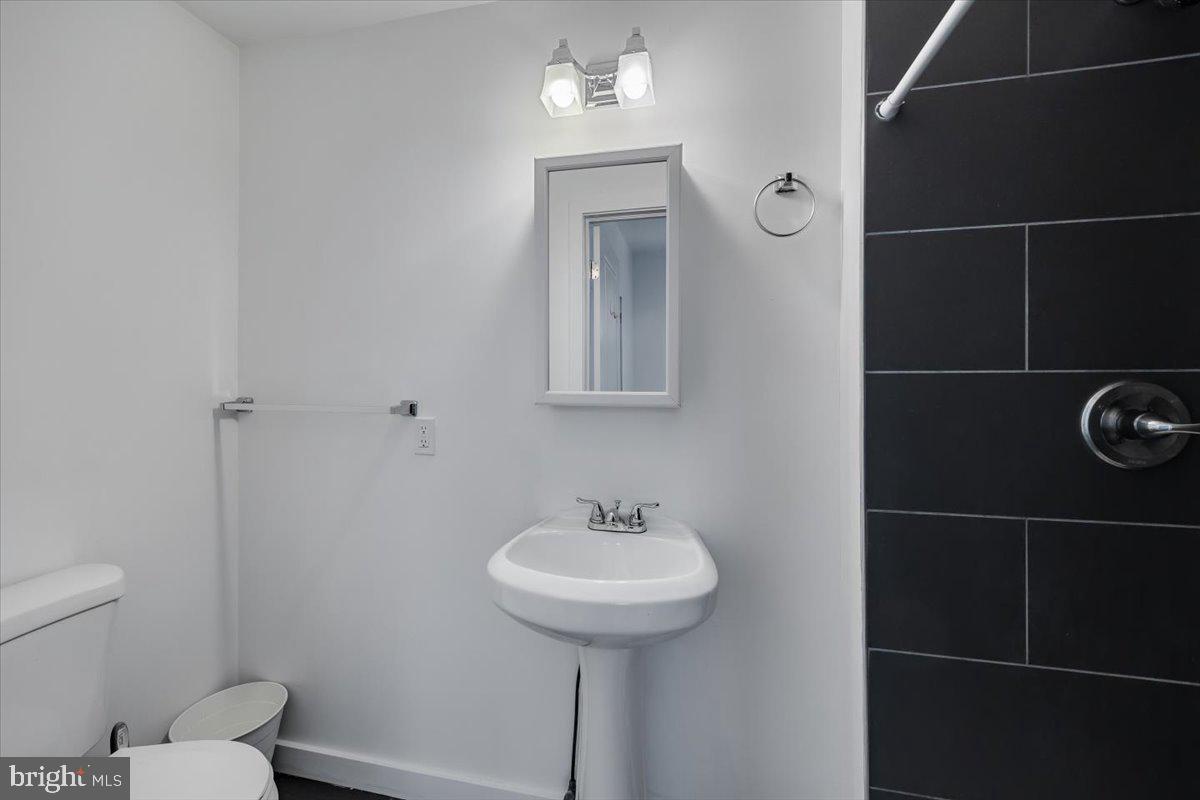 1322 North 15th Street, Unit A Philadelphia, PA 19121 - Photo 20 of 27 a bathroom with a sink toilet and a mirror