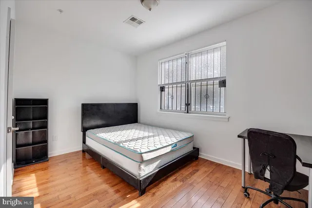 a bedroom with a bed and a chair