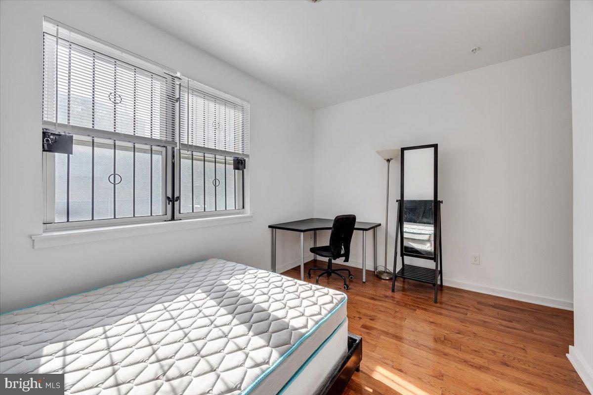 1322 North 15th Street, Unit A Philadelphia, PA 19121 - Photo 8 of 27 a bedroom with a bed table and chair