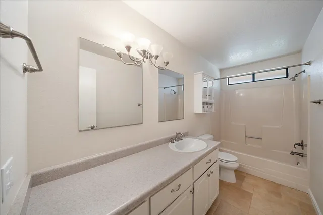 a view of a kitchen with a sink and a refrigerator