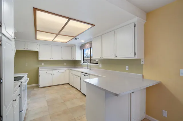 a kitchen with cabinets stainless steel appliances and a counter space