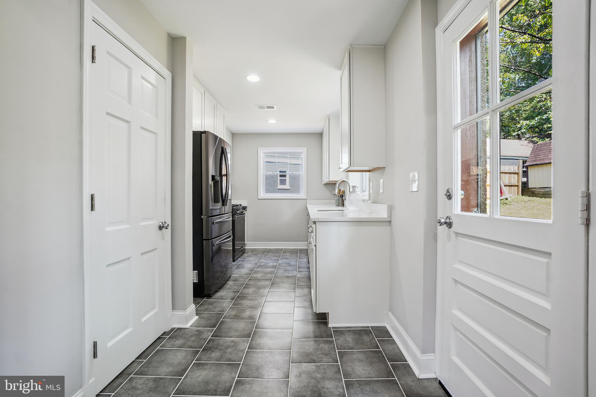514 Silver Spring Avenue Silver Spring, MD 20910 - Photo 11 of 32 a bathroom with a sink and a mirror
