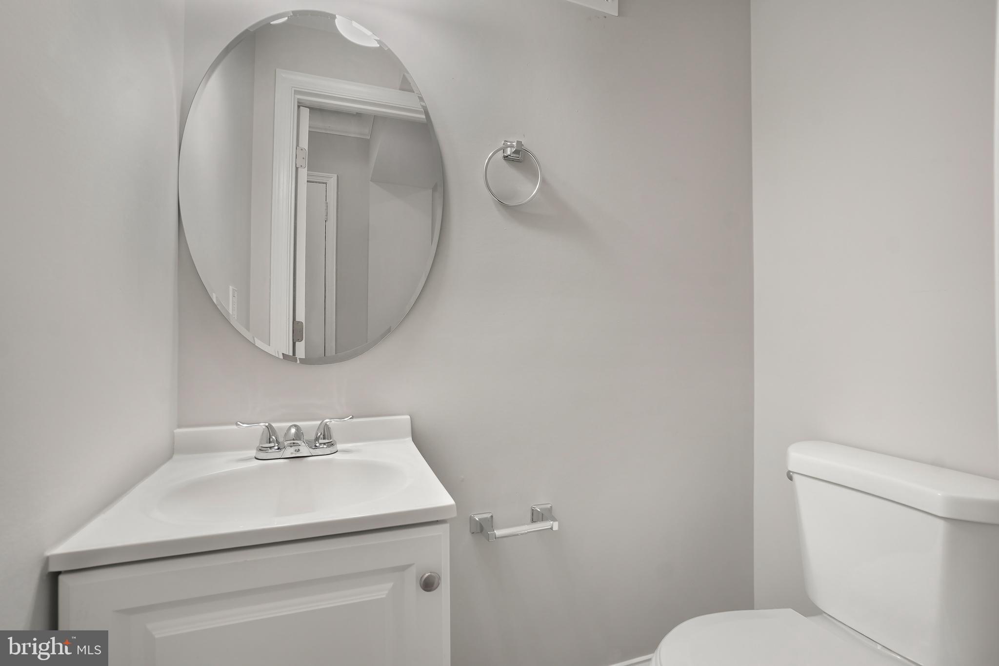 514 Silver Spring Avenue Silver Spring, MD 20910 - Photo 14 of 32 a bathroom with a sink mirror and toilet