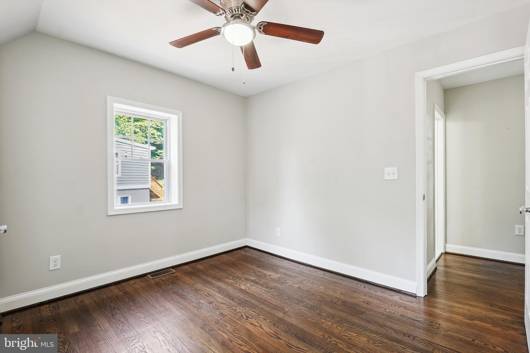 514 Silver Spring Avenue Silver Spring, MD 20910 - Photo 20 of 32 an empty room with wooden floor chandelier fan and windows