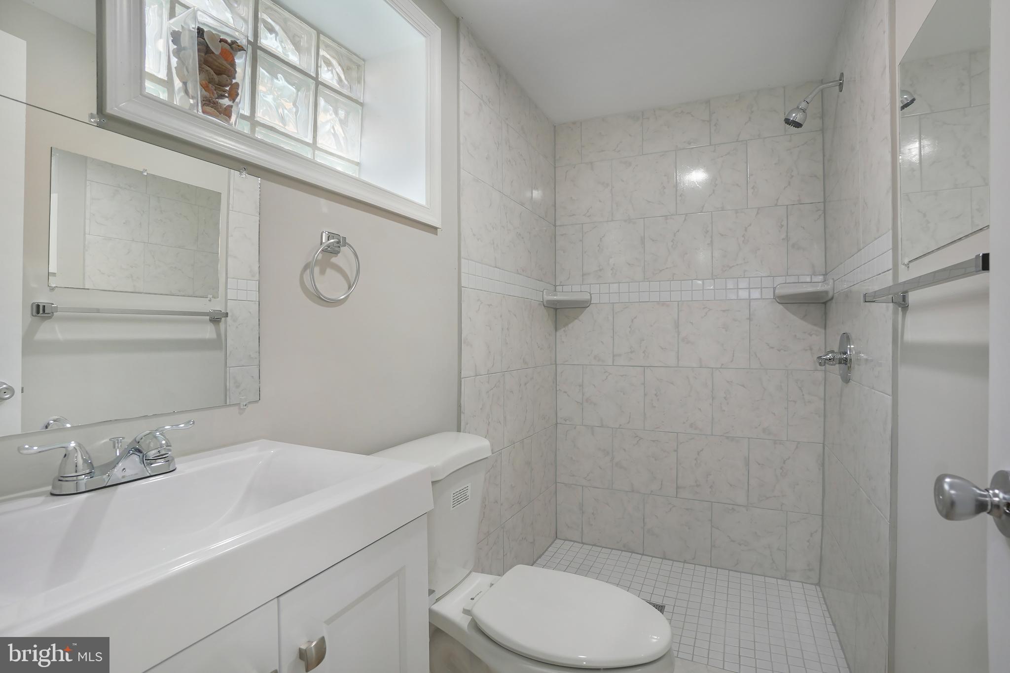 514 Silver Spring Avenue Silver Spring, MD 20910 - Photo 26 of 32 a bathroom with a sink toilet and shower