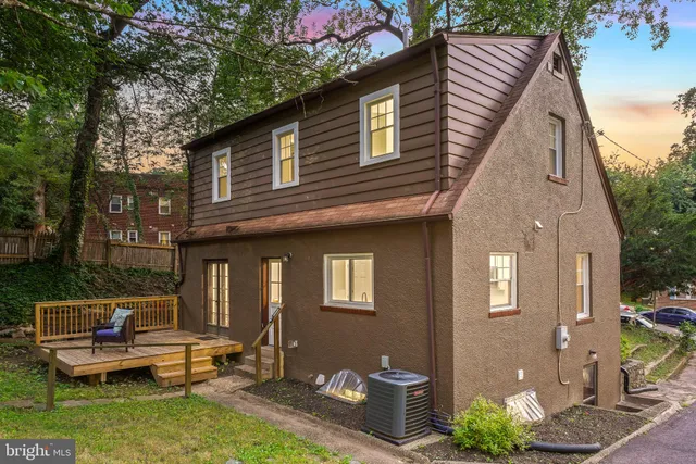 a front view of a house with a yard table and chairs