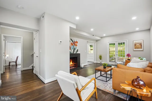 a living room with fireplace furniture and a wooden floor