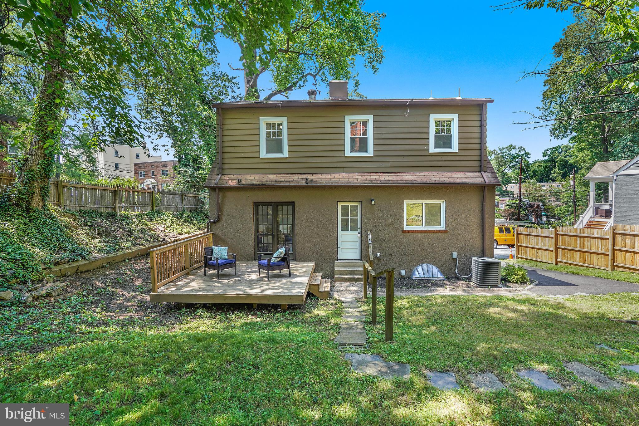 514 Silver Spring Avenue Silver Spring, MD 20910 - Photo 31 of 32 a front view of a house with a yard table and chairs