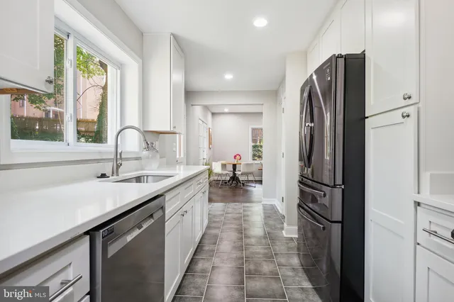 a kitchen with refrigerator and sink