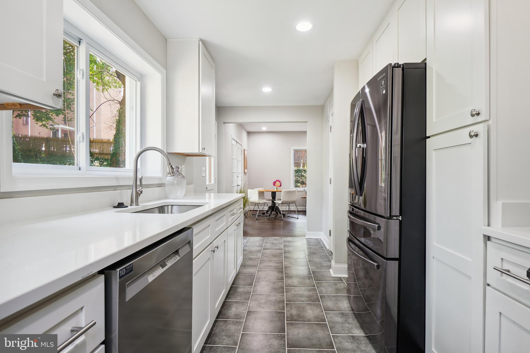 514 Silver Spring Avenue Silver Spring, MD 20910 - Photo 9 of 32 a kitchen with refrigerator and sink