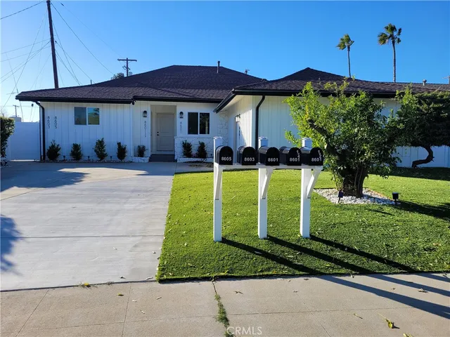 a view of a house with backyard sitting area and swimming pool