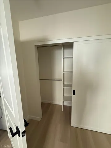 a kitchen with granite countertop a refrigerator and a stove top oven