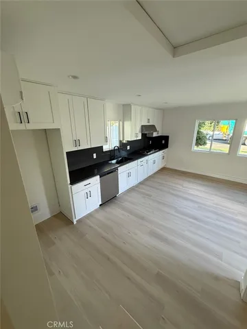 a view of walk in closet with wooden floor
