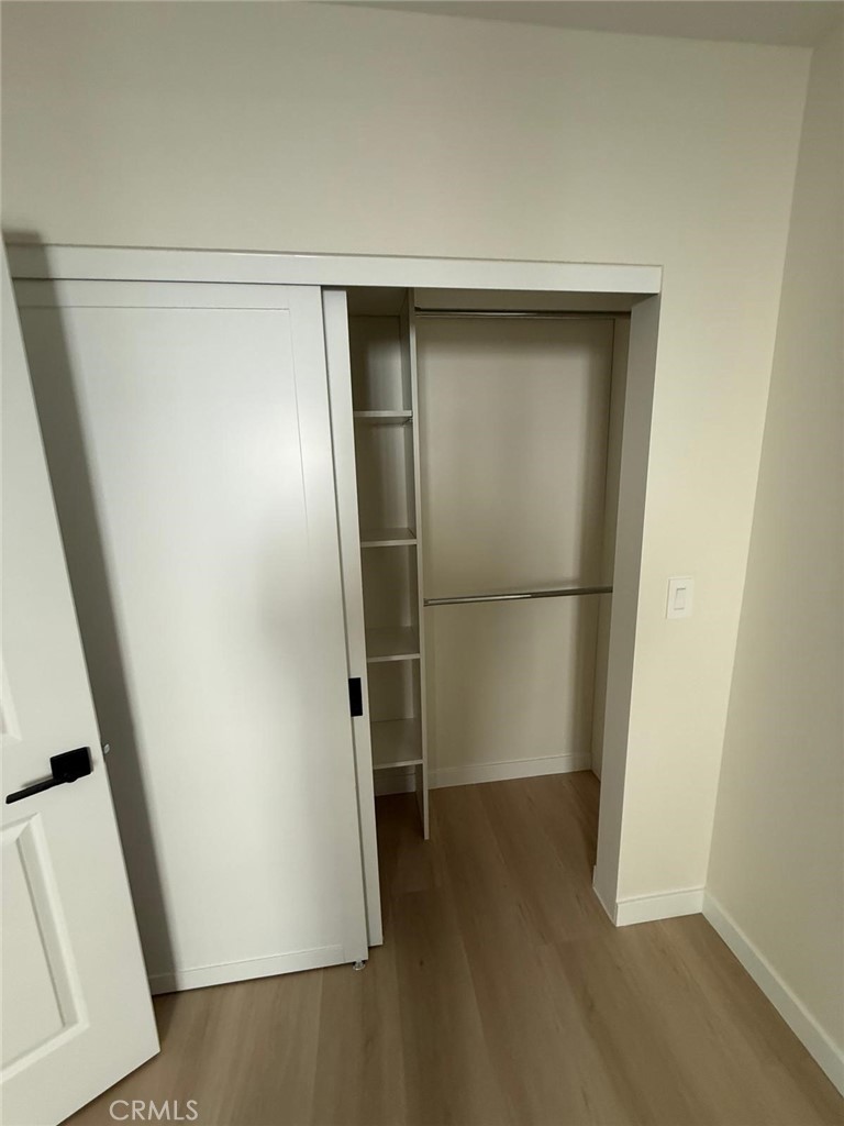 8601 Delco Avenue, Unit 1/4 Winnetka, CA 91306 - Photo 20 of 25 a view of walk in closet with wooden floor