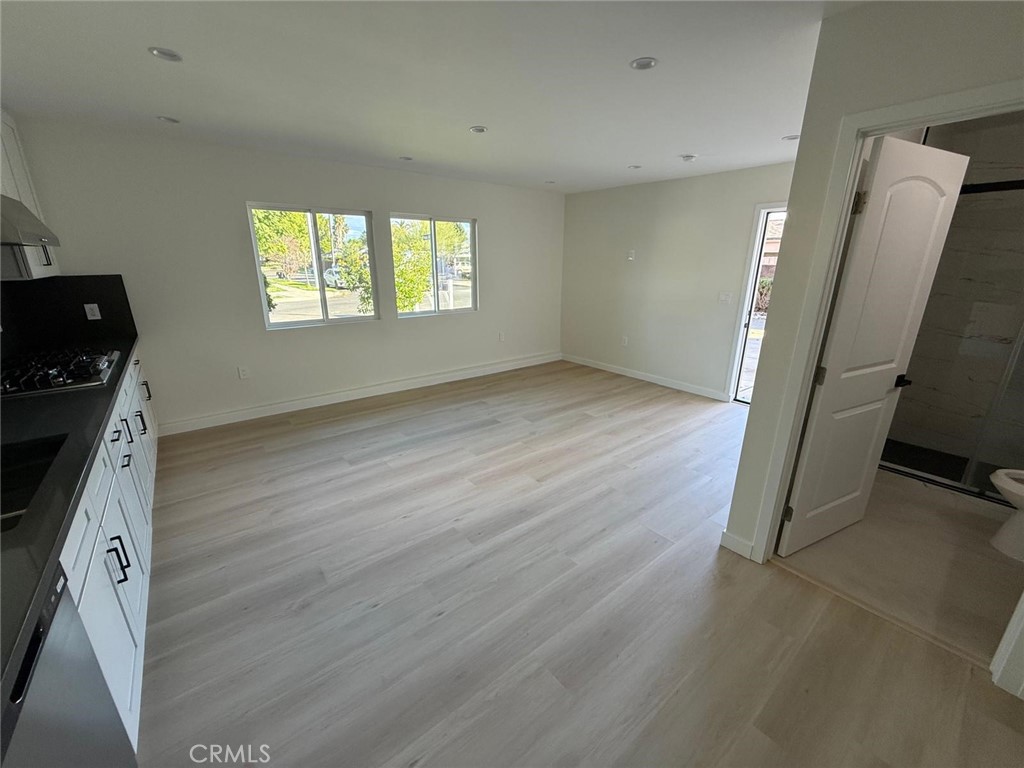 8601 Delco Avenue, Unit 1/4 Winnetka, CA 91306 - Photo 4 of 25 wooden floor in an empty room with a window