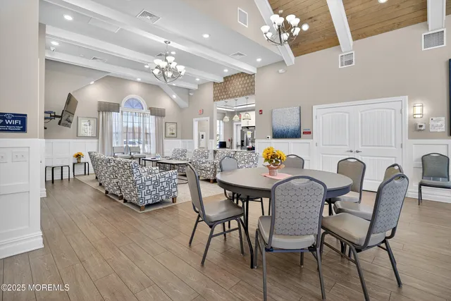 a view of a dining room with furniture and chandelier