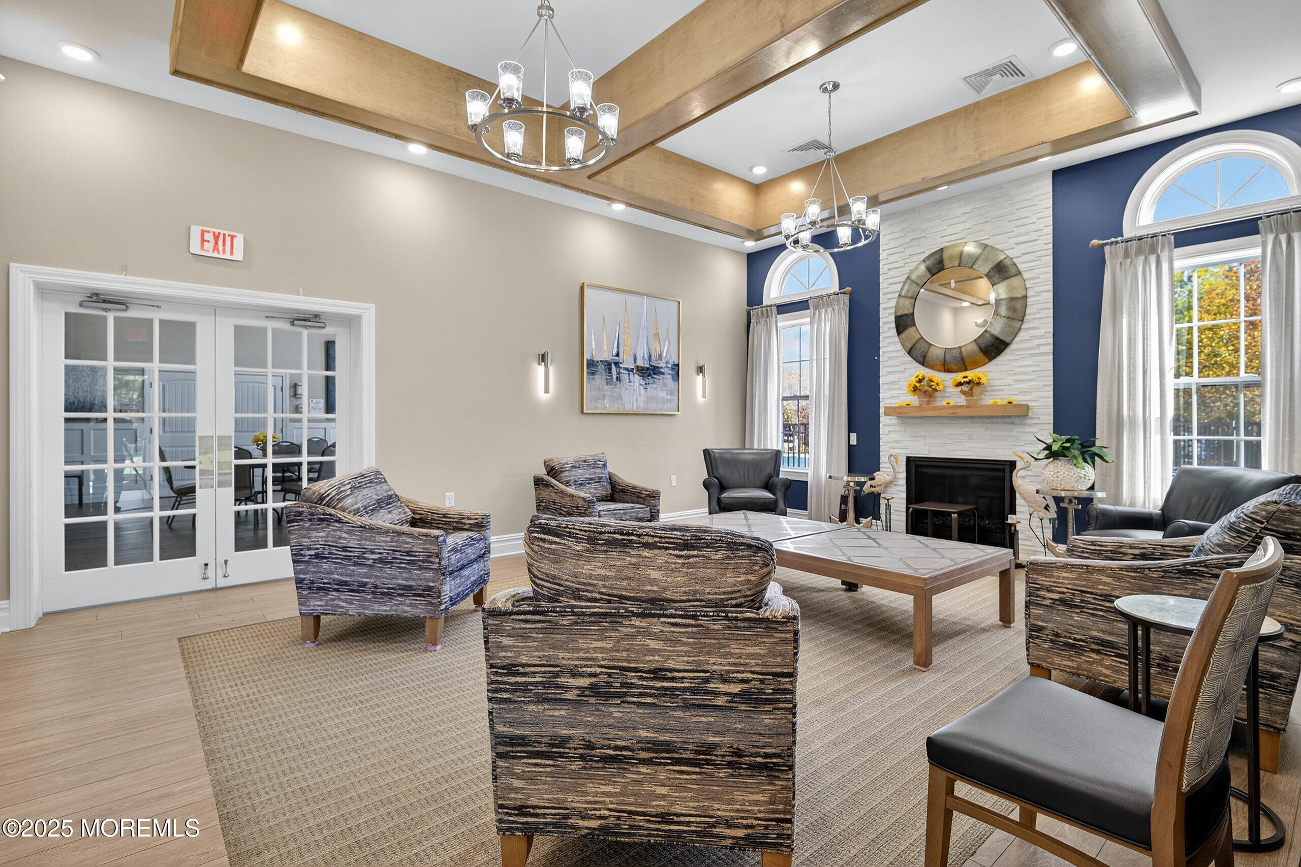 67 Grabowski Drive, Unit 321 Parlin, NJ 08859 - Photo 33 of 38 a living room with fireplace furniture and a chandelier