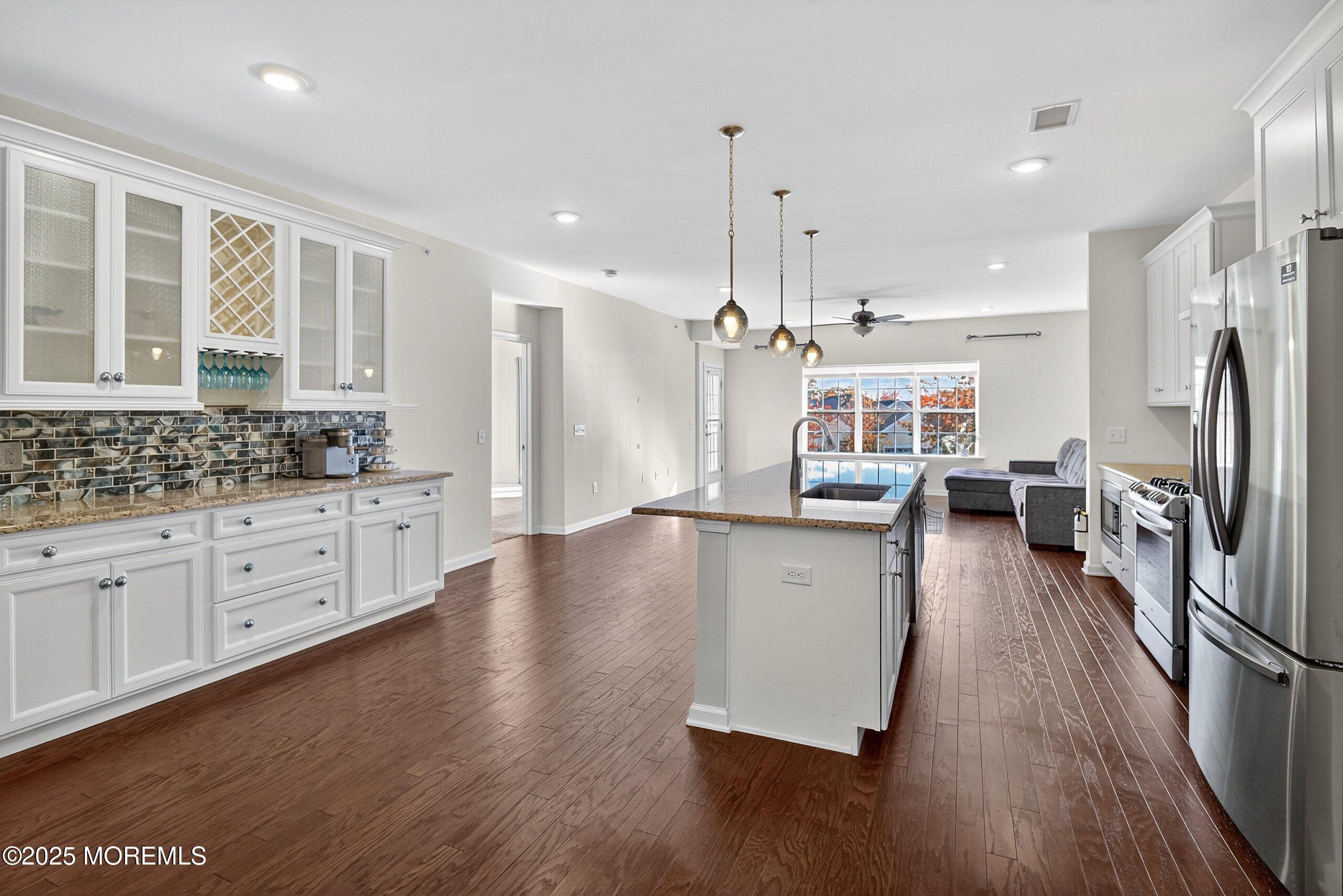 67 Grabowski Drive, Unit 321 Parlin, NJ 08859 - Photo 5 of 38 a kitchen with stainless steel appliances granite countertop a refrigerator a stove oven a sink dishwasher and white cabinets with wooden floor