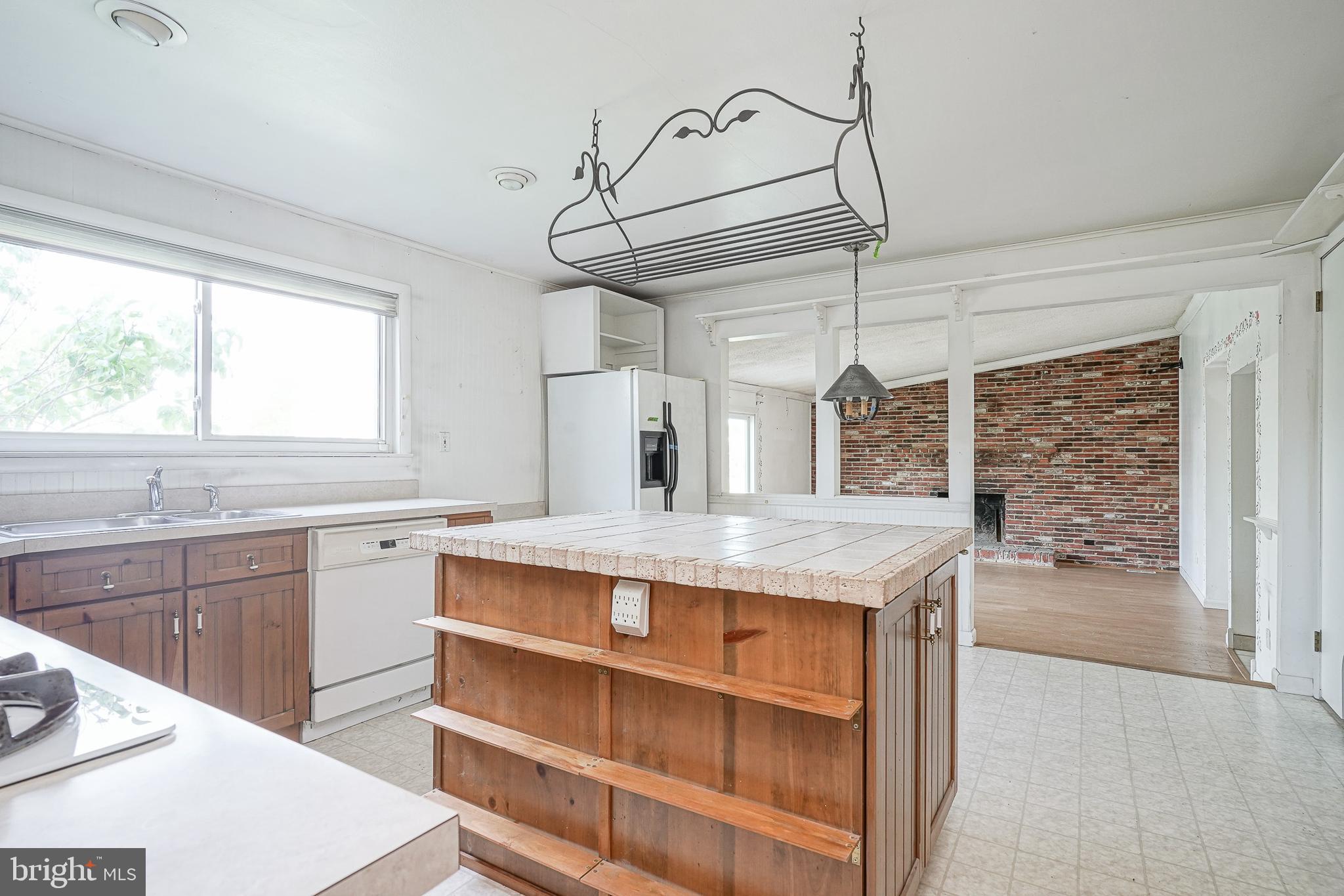 152 Kelly Driver Road Laurel Springs, NJ 08021 - Photo 11 of 30 a kitchen with a stove a sink cabinets and a window