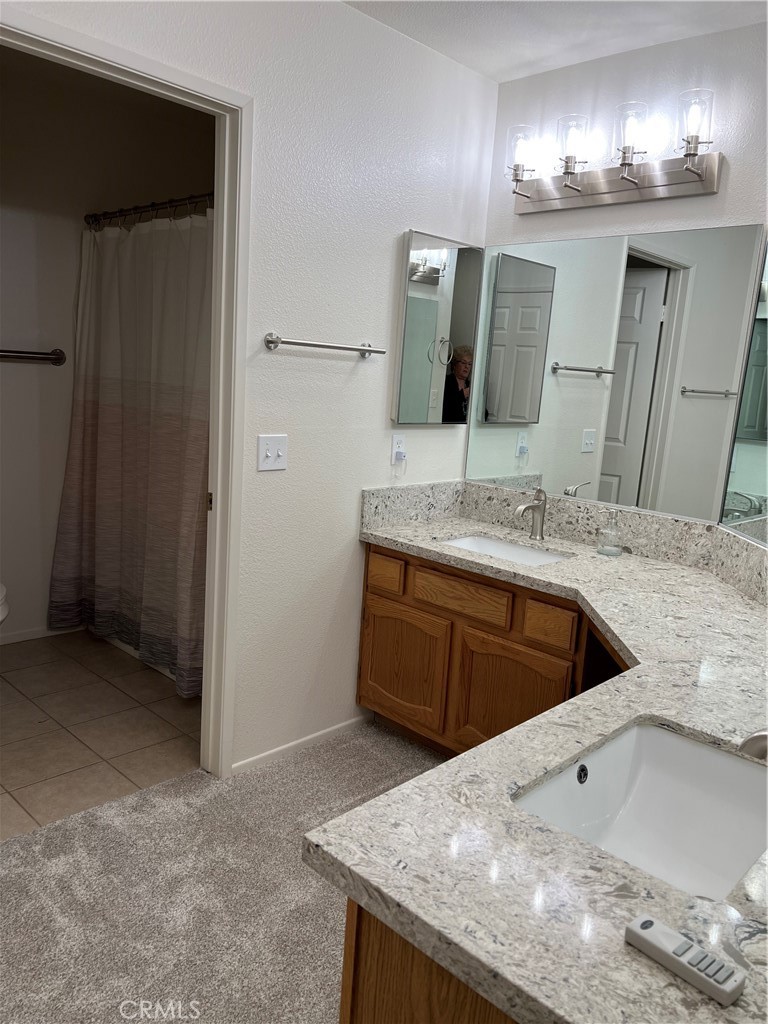 11675 Maple Street Apple Valley, CA 92308 - Photo 5 of 7 a bathroom with a granite countertop sink and a mirror