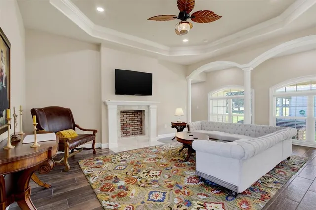 a living room with furniture a fireplace and a flat screen tv