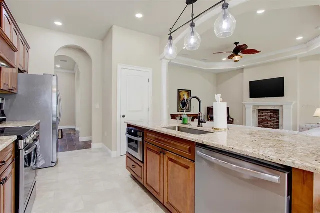 a kitchen with a sink and a stove top oven with wooden floor
