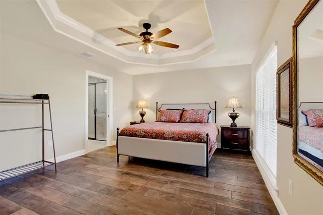 a bedroom with a bed and a chandelier